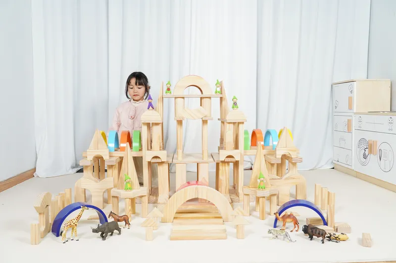children using wooden building blocks in preschool classroom learning centers