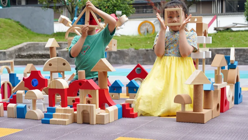 block play activities for preschoolers showing children building colorful wooden structures
