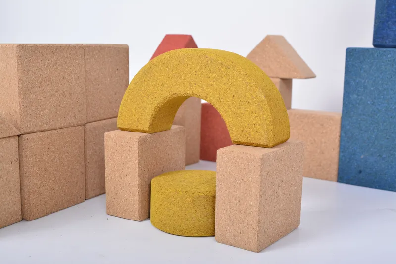 Natural cork building blocks showing nine different shapes and five vibrant colors