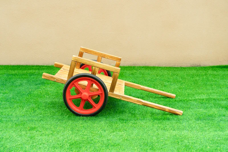 Children playing with carbonized wooden transportation vehicles