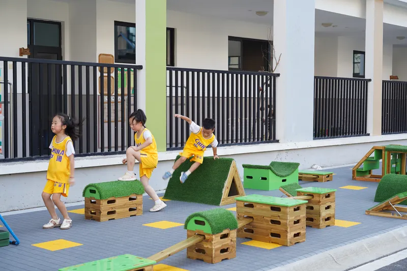 outdoor kids obstacle course equipment integrated into preschool playground