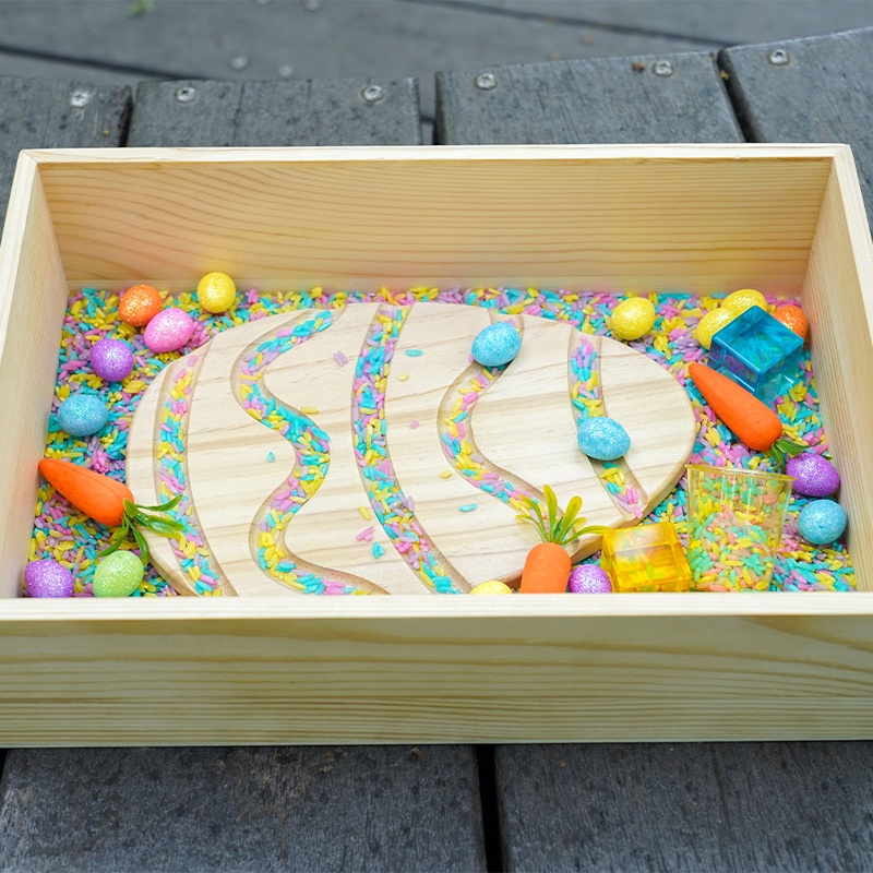 Easter egg-sensory box - Pine wood and plastic construction with rice, bees, and building blocks