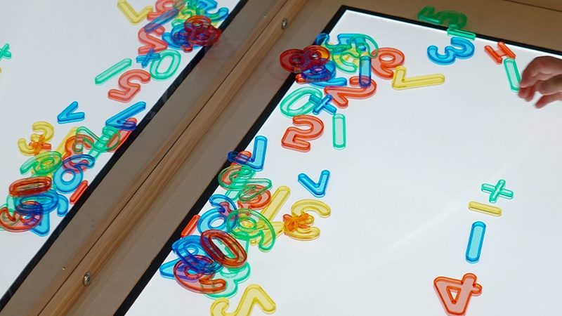 Sensory Light Table children actively engaged in learning activities