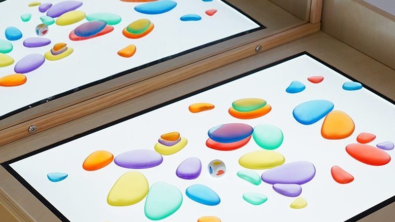 Sensory Light Table surface with translucent materials arranged on it