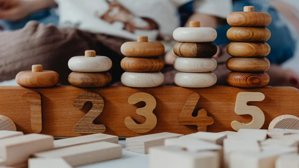 Pre K Activities mathematical learning scene with wooden number toys and counting manipulatives