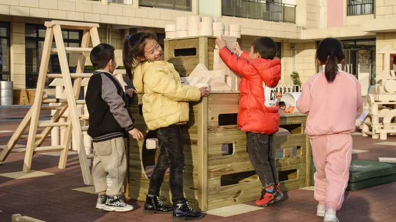 Building blocks for preschoolers - group of children working together on construction project