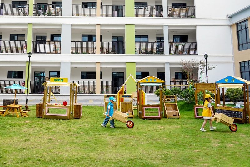 Children learning math and social skills in Play Village wooden restaurant area