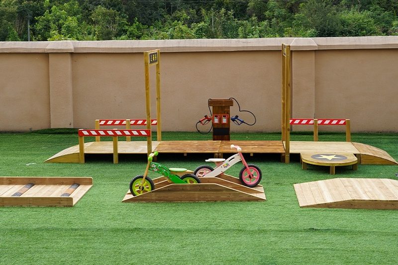 outdoor games for preschoolers in professionally designed playground with wooden equipment