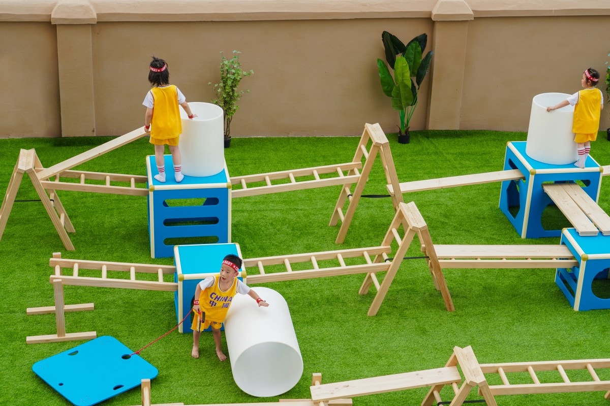 Anji Play Explained: 5 Principles of True Play 2 Children exploring challenge and manageable risk with movable climbing structures