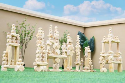220-piece natural giant faceted wooden stacking blocks arranged as towers and large outdoor structures