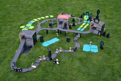 Wooden draw-and-build city set with black road tracks garages vehicles traffic signs and landscape panels