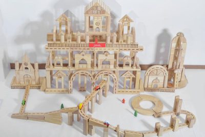 Advanced preschool wooden blocks arranged as a large architectural city and railway layout