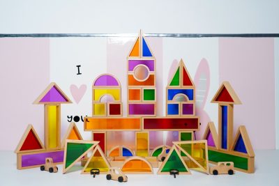 Close-up of jumbo beechwood acrylic window blocks casting colorful light reflections
