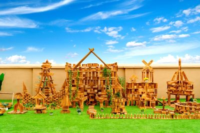 1633-piece large outdoor building blocks Deluxe Set arranged into an expansive carbonized wooden construction environment
