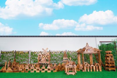 750-piece large outdoor wooden building block set arranged into multiple carbonized wooden architectural structures