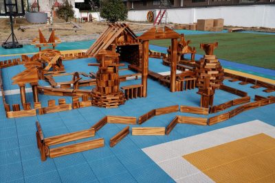 866-piece outdoor wooden building blocks Deluxe Set arranged into large architectural structures