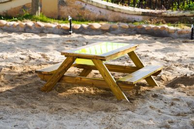 outdoor wooden sand and water activity table with integrated bench seating