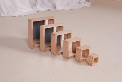 6-piece wooden nesting pyramid mirror set with graduated beech wood frames and reflective center panels