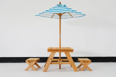 kids picnic table with umbrella and wooden outdoor seating for preschool activities