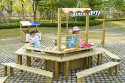 kids outdoor table set with six modular wooden tables arranged around a preschool activity area