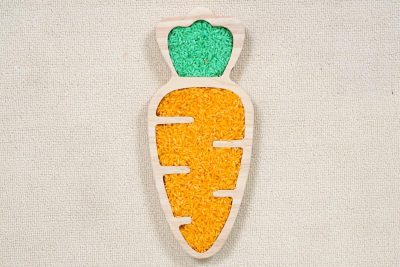 carrot sensory tray made from rubberwood with green and orange rice in recessed leafy and root-shaped areas