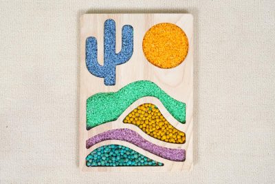 desert sensory tray made from rubberwood with cactus sun and layered landscape compartments filled with colored rice