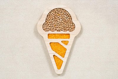 ice cream sensory tray made from rubberwood with divided scoop and cone sections filled with colorful sensory materials