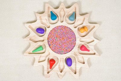 sunflower sensory tray made from rubberwood with colorful rice and petal sorting compartments