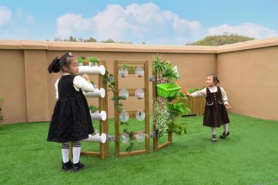 three sided vertical garden planter for kids with multiple gardening faces in an outdoor classroom