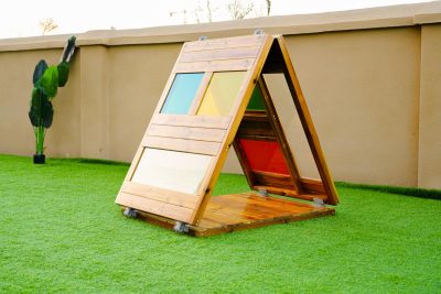 kids play tent made from wood with colored acrylic panels for preschool outdoor role play